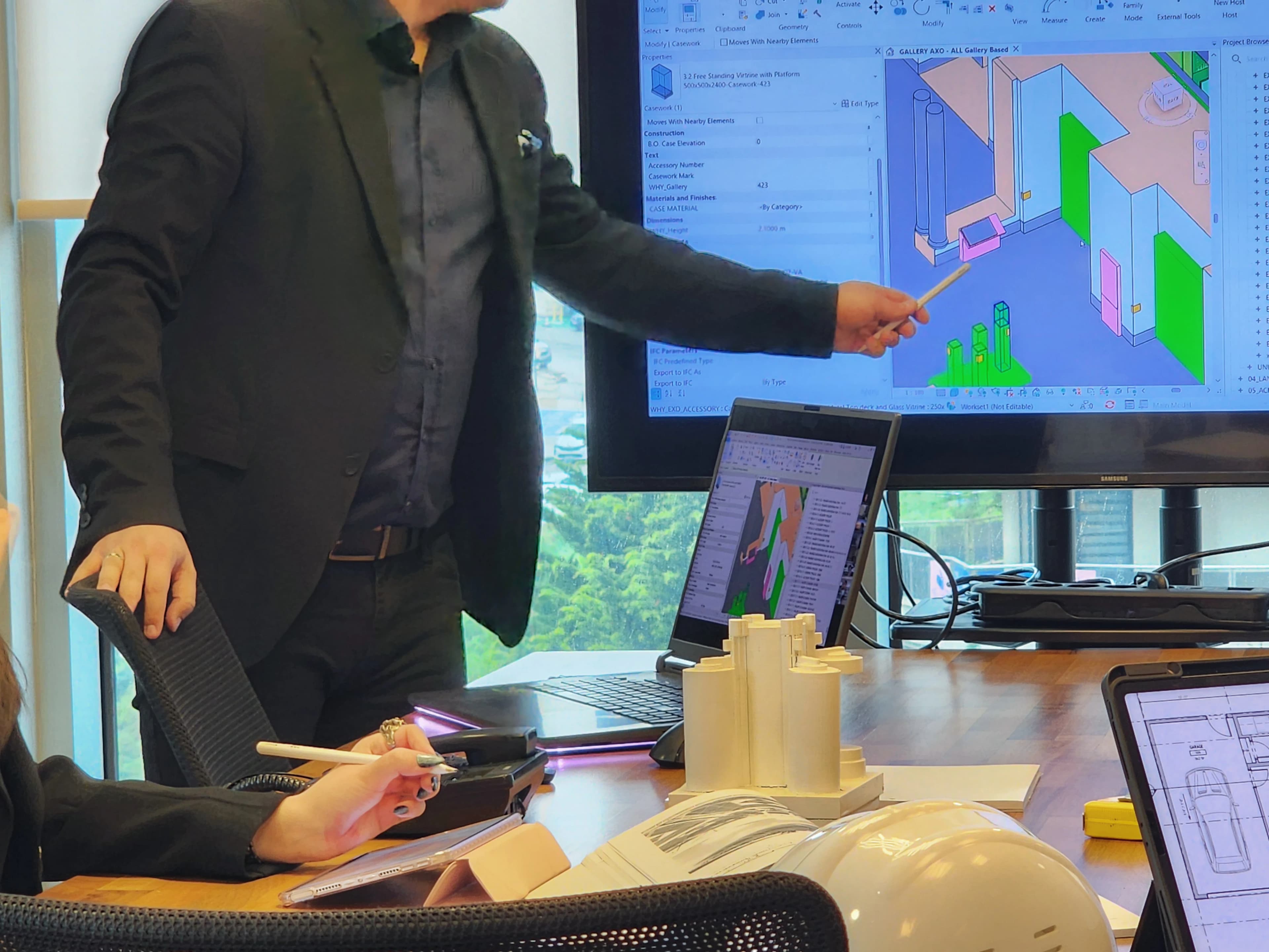 Standing BIM sunumu — 3D model büyük ekranda projenin teknik detayları
